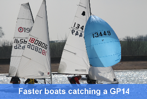 The faster Aero and Laser boats are nearly catching the slower GP14 as they round a mark