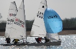The faster Aero and Laser boats are nearly catching the slower GP14 as they round a mark